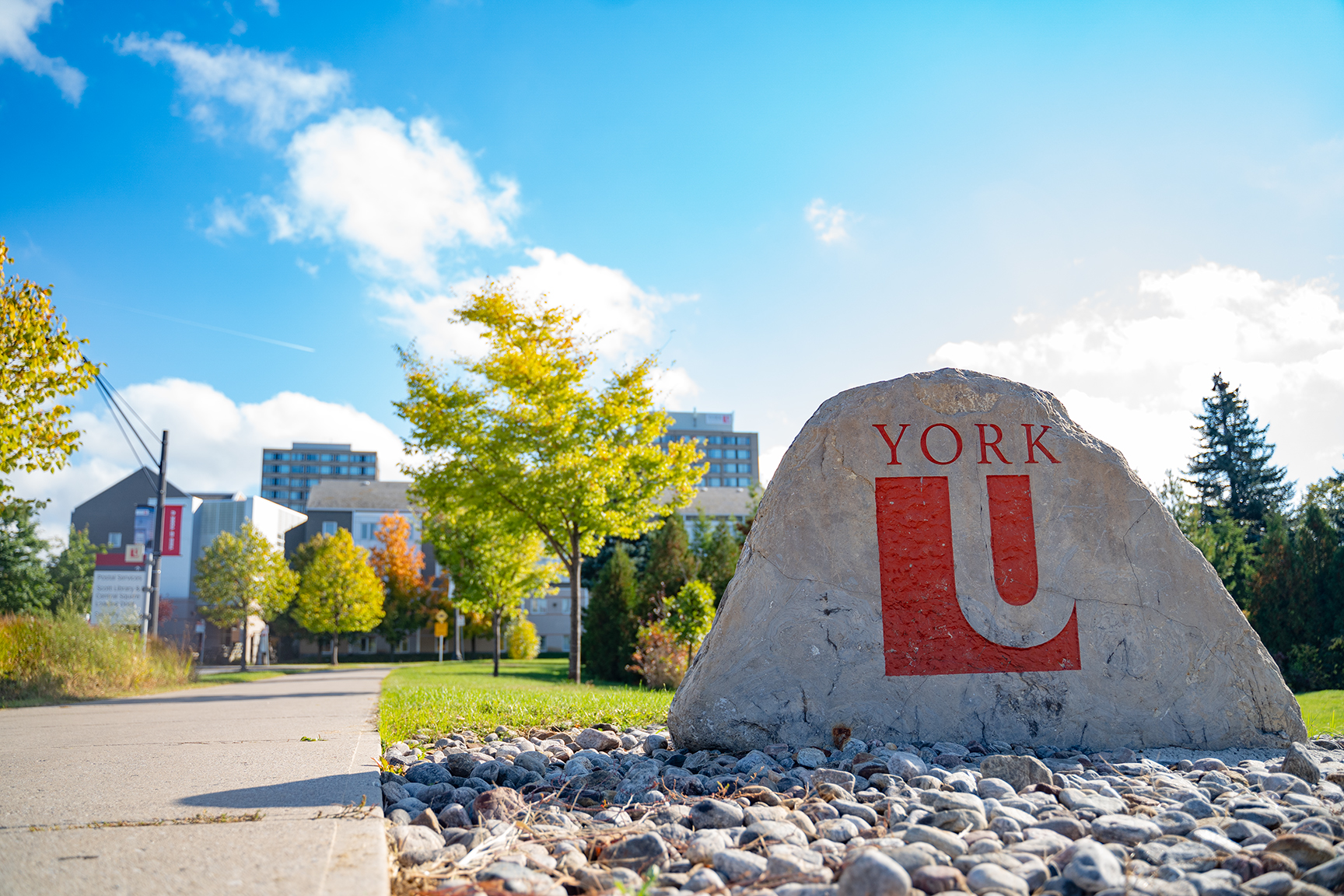 York University west entrance stone with the red York U emblem